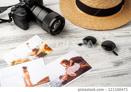 Photo camera with colorful printer photos on gray desk Photo camera with colorful printer photos on gray desk 121100471