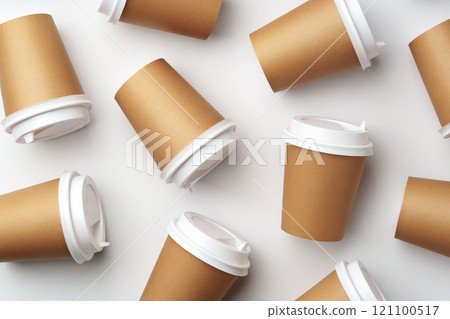 A collection of disposable coffee cups arranged artfully on a white surface A collection of disposable coffee cups arranged artfully on a white surface 121100517