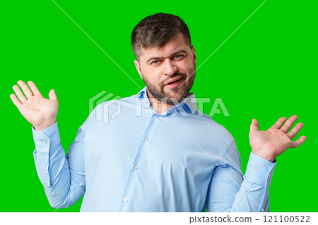 A man playfully posing with a quirky expression against a bright green background A man playfully posing with a quirky expression against a bright green background 121100522