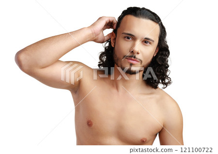 Young man with curly hair thoughtfully posing against a plain background Young man with curly hair thoughtfully posing against a plain background 121100722