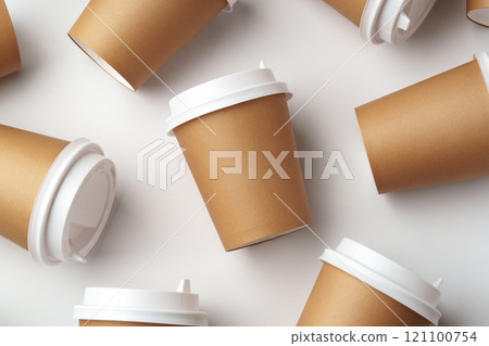 A collection of disposable coffee cups arranged artfully on a white surface A collection of disposable coffee cups arranged artfully on a white surface 121100754