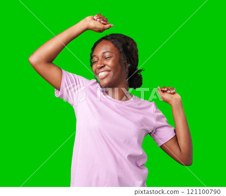 A young woman with braids expresses excitement with a clenched fist against a bright green background A young woman with braids expresses excitement with a clenched fist against a bright green background 121100790