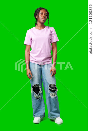 Young woman with an expression of contemplation poses against a bright green background Young woman with an expression of contemplation poses against a bright green background 121100826