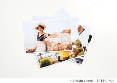 Printed colorful photos of women portraits against gray background 121100898