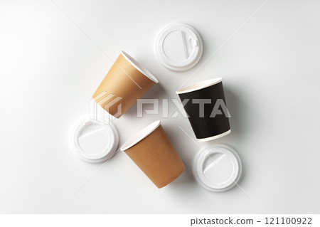 Three disposable coffee cups arranged on a white background Three disposable coffee cups arranged on a white background 121100922