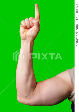 A person raising one finger against a vibrant green background 121100974