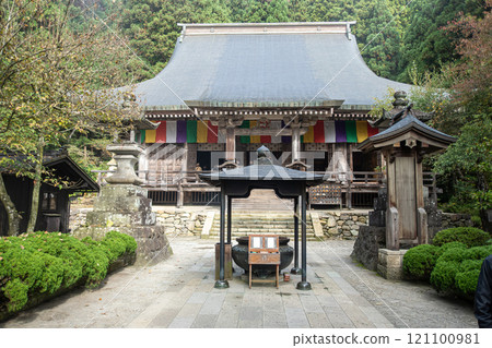 Risshaku-ji Temple at Yamadera, Yamagata, Japan. Historic temple surrounded by lush greenery and colorful flags. Risshaku-ji Temple at Yamadera, Yamagata, Japan. Historic temple surrounded by lush greenery and colorful flags. 121100981