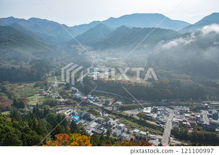 Risshaku-ji Temple at Yamadera, Yamagata, Japan. Scenic view of a mountainous landscape with a village below. 121100997