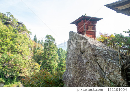 Risshaku-ji Temple at Yamadera, Yamagata, Japan. Scenic view of a chimney surrounded by lush greenery. Risshaku-ji Temple at Yamadera, Yamagata, Japan. Scenic view of a chimney surrounded by lush greenery. 121101004