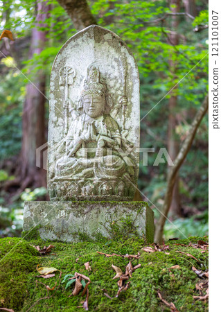 Risshaku-ji Temple at Yamadera, Yamagata, Japan. Buddhist statue surrounded by lush greenery and moss. 121101007