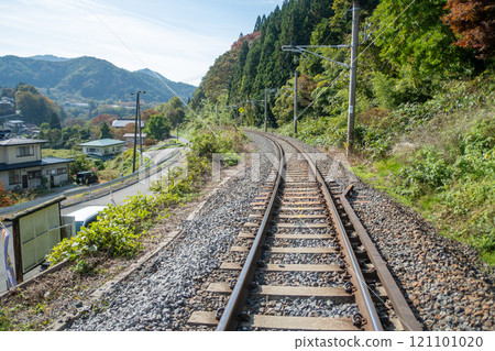 Yamadera, Yamagata, Japan. Scenic railway track winding through lush greenery and mountains. Yamadera, Yamagata, Japan. Scenic railway track winding through lush greenery and mountains. 121101020