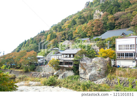Yamadera, Yamagata, Japan. Scenic hillside with autumn foliage and traditional buildings. 121101031