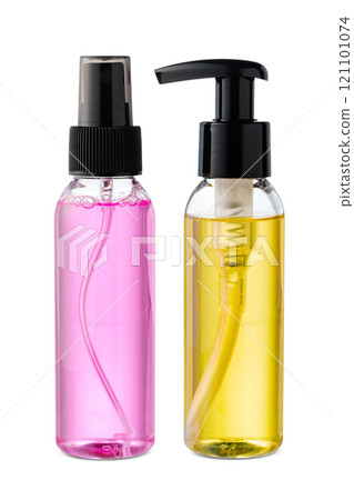 Various bottles with colored liquids and pumps arranged on white background 121101074