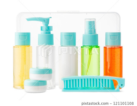 Variety of colorful personal care bottles and grooming accessories arranged on a white surface Variety of colorful personal care bottles and grooming accessories arranged on a white surface 121101108