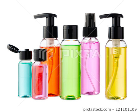 Variety of colorful personal care bottles and grooming accessories arranged on a white surface Variety of colorful personal care bottles and grooming accessories arranged on a white surface 121101109