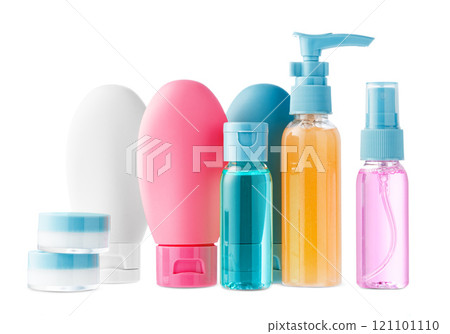Variety of colorful personal care bottles and grooming accessories arranged on a white surface Variety of colorful personal care bottles and grooming accessories arranged on a white surface 121101110