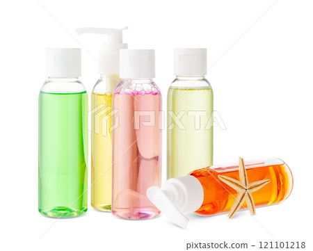 Assorted skincare products displayed on a white surface with a seashell 121101218