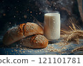 Freshly baked bread rolls with a sprinkle of sesame seeds sit invitingly beside a tall glass of milk. Soft light filters through, creating a cozy atmosphere reminiscent of a peaceful morning. 121101781