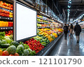 Brightly colored fruits and vegetables are displayed in abundance along the shelves of a bustling grocery store. 121101790