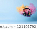 A pair of stylish headphones appears to float amidst vibrant clouds of pink and yellow hues on a serene blue backdrop, symbolizing the joy and freedom of music. 121101792