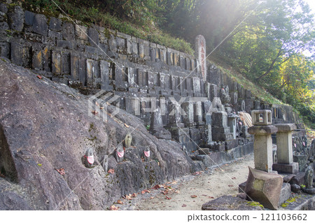 Risshaku-ji Temple at Yamadera, Yamagata, Japan. Ancient stone carvings on a hillside with lush greenery. Risshaku-ji Temple at Yamadera, Yamagata, Japan. Ancient stone carvings on a hillside with lush greenery. 121103662