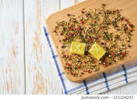 Bouillon cubes and dry spices on a on a cutting board. Top view. Bouillon cubes and dry spices on a on a cutting board. Top view. 121104241