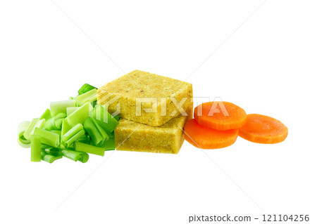 chicken bouillon cubes and fresh vegetables for soup isolated on a white background. chicken bouillon cubes and fresh vegetables for soup isolated on a white background. 121104256