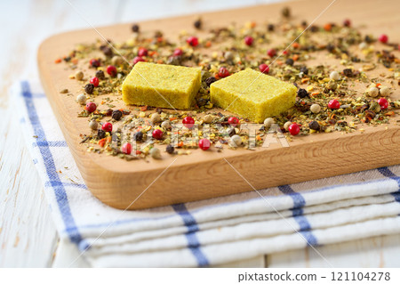 Bouillon cubes and dry spices on a on a cutting board. Bouillon cubes and dry spices on a on a cutting board. 121104278