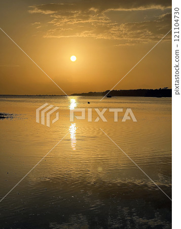 Beautiful sunset on ocean beach. Sky is reflecting at water. Philippines, Bohol Beautiful sunset on ocean beach. Sky is reflecting at water. Philippines, Bohol 121104730