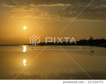 Beautiful sunset on ocean beach. Sky is reflecting at water. Philippines, Bohol Beautiful sunset on ocean beach. Sky is reflecting at water. Philippines, Bohol 121104751