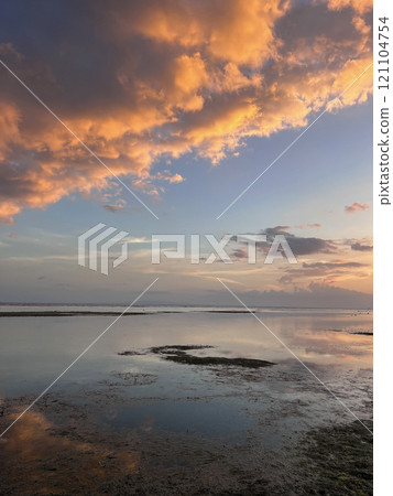 Beautiful sunset on ocean beach. Sky is reflecting at water. Philippines, Bohol Beautiful sunset on ocean beach. Sky is reflecting at water. Philippines, Bohol 121104754