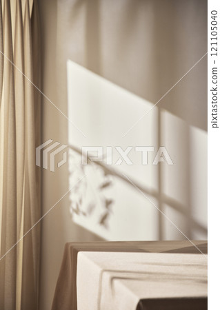 Warm sunlight streaming in through the window, beige background, flowers, vases, and a table with plants. Harmony of light and shadow. Warm sunlight streaming in through the window, beige background, flowers, vases, and a table with plants. Harmony of light and shadow. 121105040