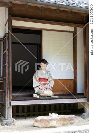 A woman in a kimono standing on the veranda 121105500
