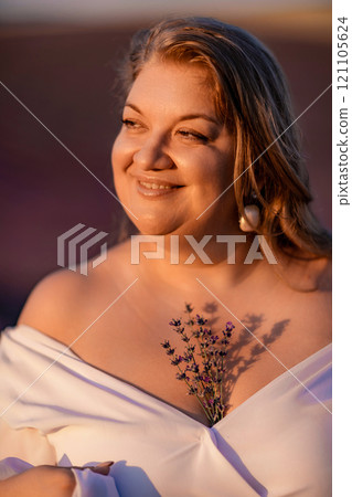 woman poses in lavender field at sunset. Happy woman in white dress holds lavender bouquet. Aromatherapy concept, lavender oil, photo session in lavender woman poses in lavender field at sunset. Happy woman in white dress holds lavender bouquet. Aromatherapy concept, lavender oil, photo session in lavender 121105624