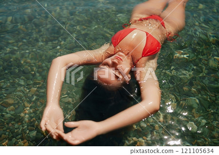 Happy woman sea relaxing floating in transparent sea water on summer holiday. Travel leisure recreation lifestyle, female in nature. 121105634