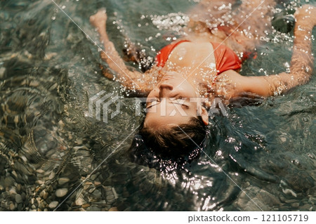 Happy woman sea relaxing floating in transparent sea water on summer holiday. Travel leisure recreation lifestyle, female in nature. Happy woman sea relaxing floating in transparent sea water on summer holiday. Travel leisure recreation lifestyle, female in nature. 121105719