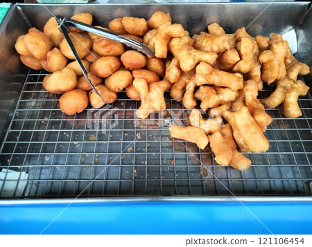 traditional yu char kway on grill for sale in morning market 121106454