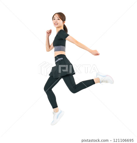 A woman jumping in sportswear. A transparent full-body photo PNG precisely cut by hand. A woman jumping in sportswear. A transparent full-body photo PNG precisely cut by hand. 121106695