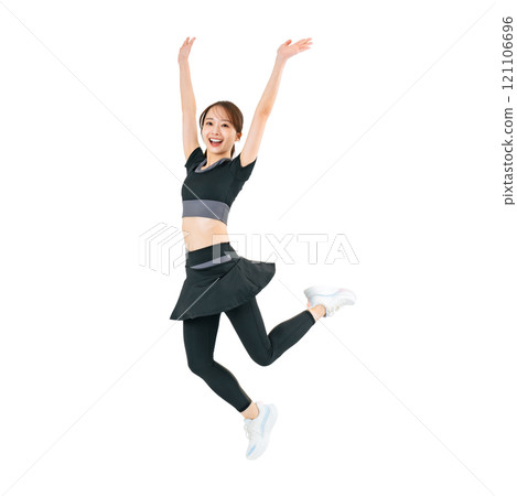A woman jumping in sportswear. A transparent full-body photo PNG precisely cut by hand. 121106696