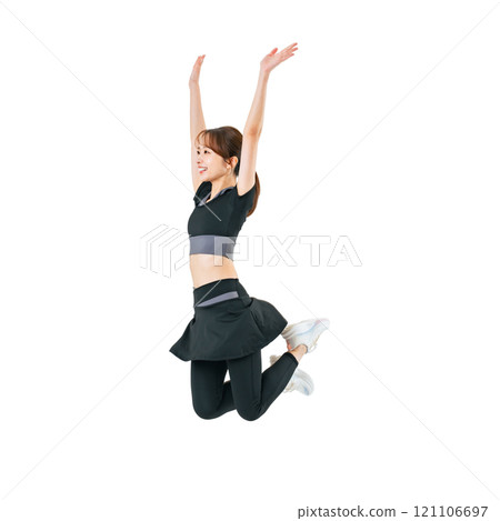 A woman jumping in sportswear. A transparent full-body photo PNG precisely cut by hand. 121106697