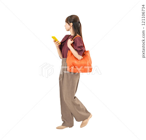 A woman in casual wear walking with a smartphone. A transparent full-body photo PNG with precise hand-cut background 121106734