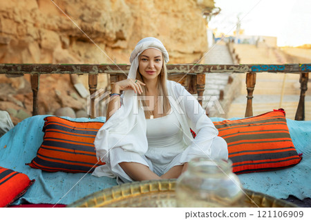Portrait of a beautiful woman in Arabic clothing in Egypt during sunset. 121106909