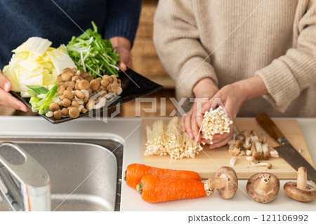 A middle-aged to senior couple preparing hotpot in the kitchen A middle-aged to senior couple preparing hotpot in the kitchen 121106992
