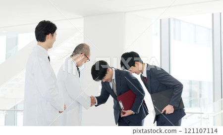 A doctor and a salesman shaking hands A doctor and a salesman shaking hands 121107114