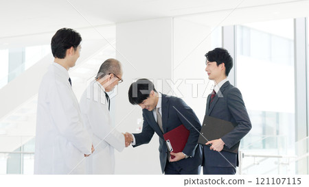 A doctor and a salesman shaking hands A doctor and a salesman shaking hands 121107115