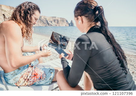 Couple Laptop Beach Planning Summer Vacation 121107396