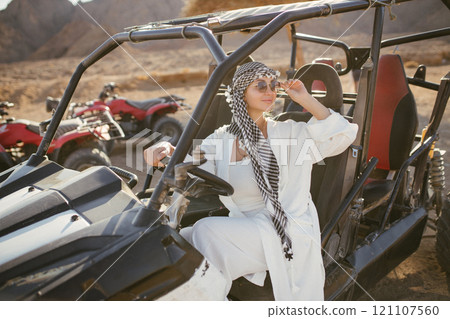 Woman tourist on quad bike ATV safari with desert background of Sharm El Sheikh Egypt 121107560