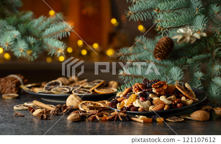 Christmas still-life with spruce branches, dried fruits, and spices. 121107612