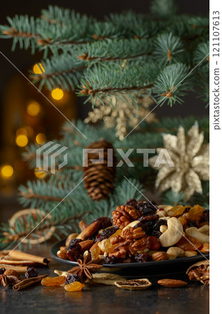Christmas still-life with spruce branches, dried fruits, and spices. 121107613