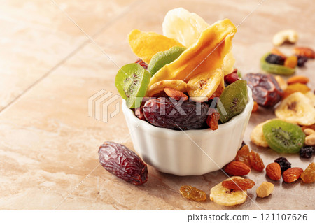 Dried tropical fruits with various nuts and raisins. 121107626
